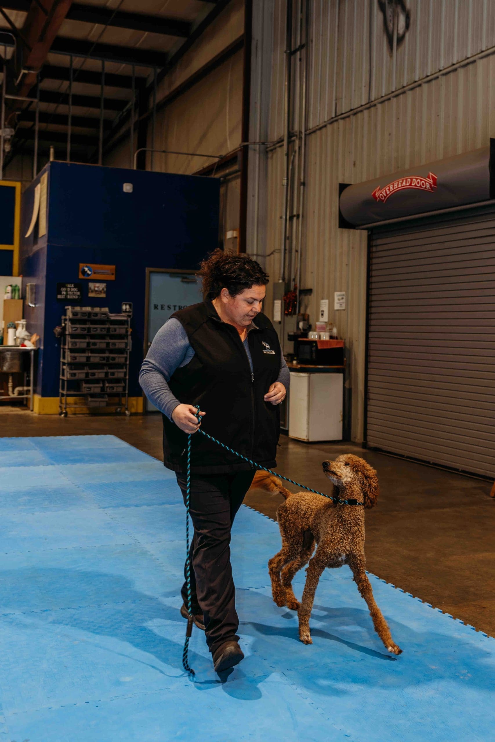 Erin working with a Doberman during a training session at Independent K-9